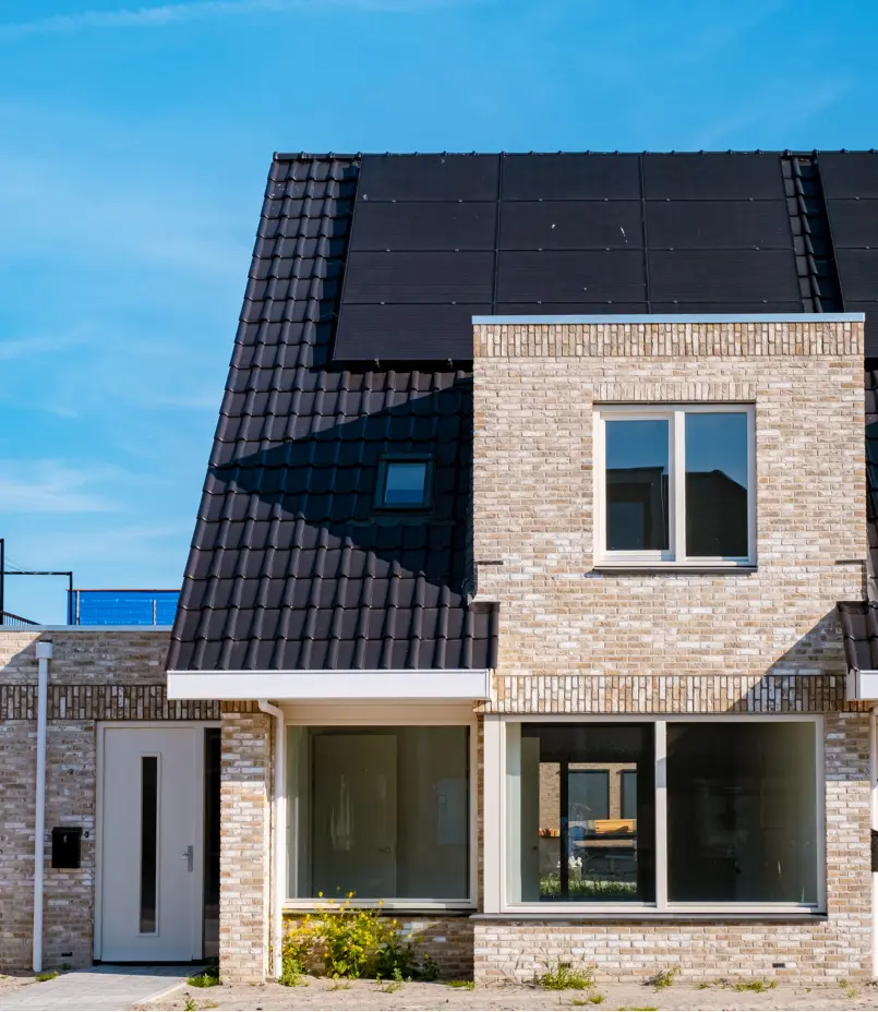 black solar panels on black roof and brick house